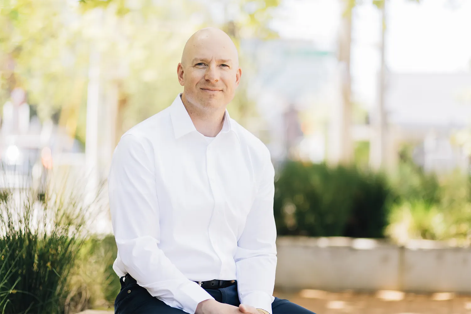 Ben Huckett, owner of Strong Mind Psychiatry, sitting outside psychiatry office