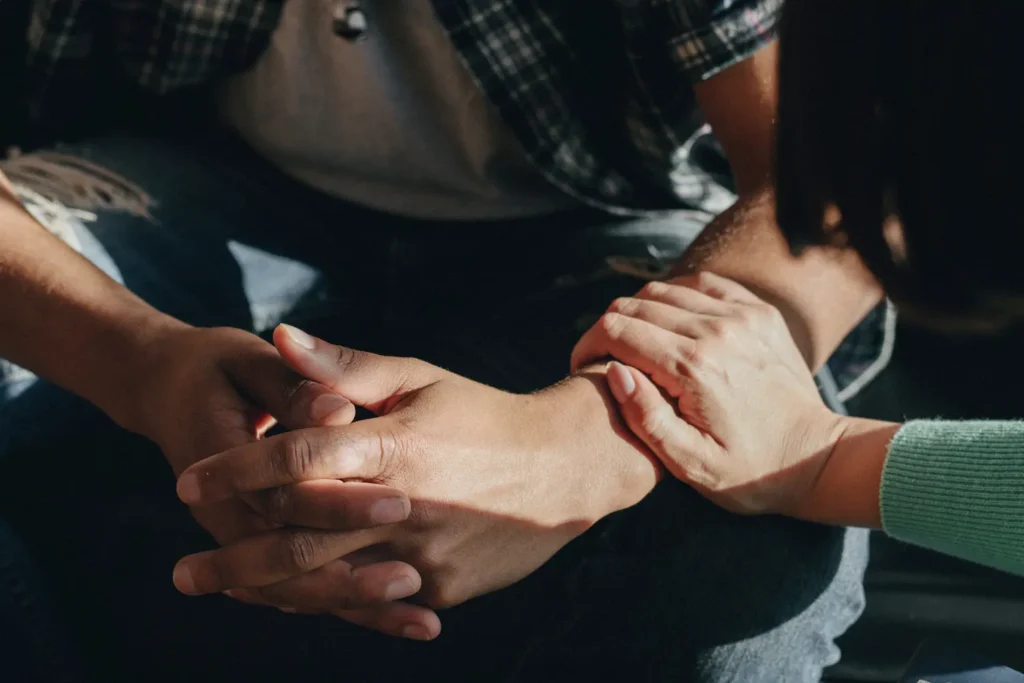 Supportive hand on person’s arm, symbolizing help for anxiety and depression — Strong Mind Psychiatry
