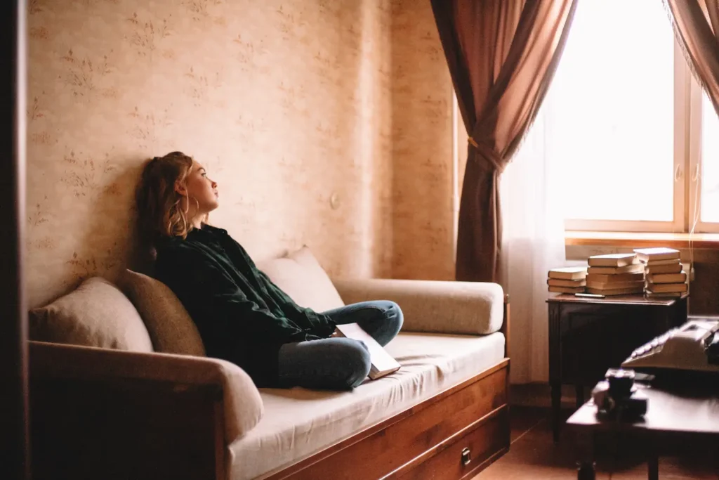 Woman alone in room, experiencing the first signs of schizophrenia