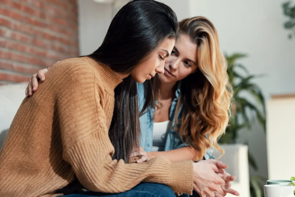 A woman helping her friend with schizophrenia and supporting her