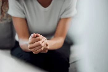 A person sitting with their hands clasped in Vancouver WA.