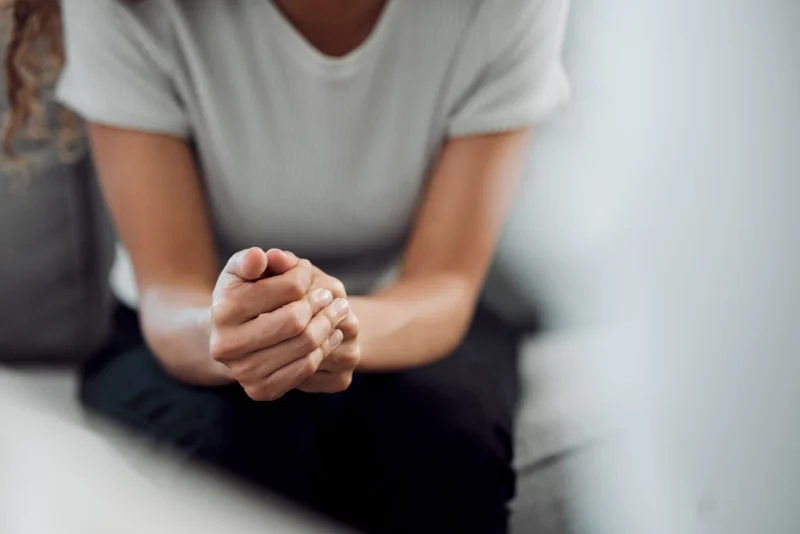 A person sitting with their hands clasped in Vancouver WA.